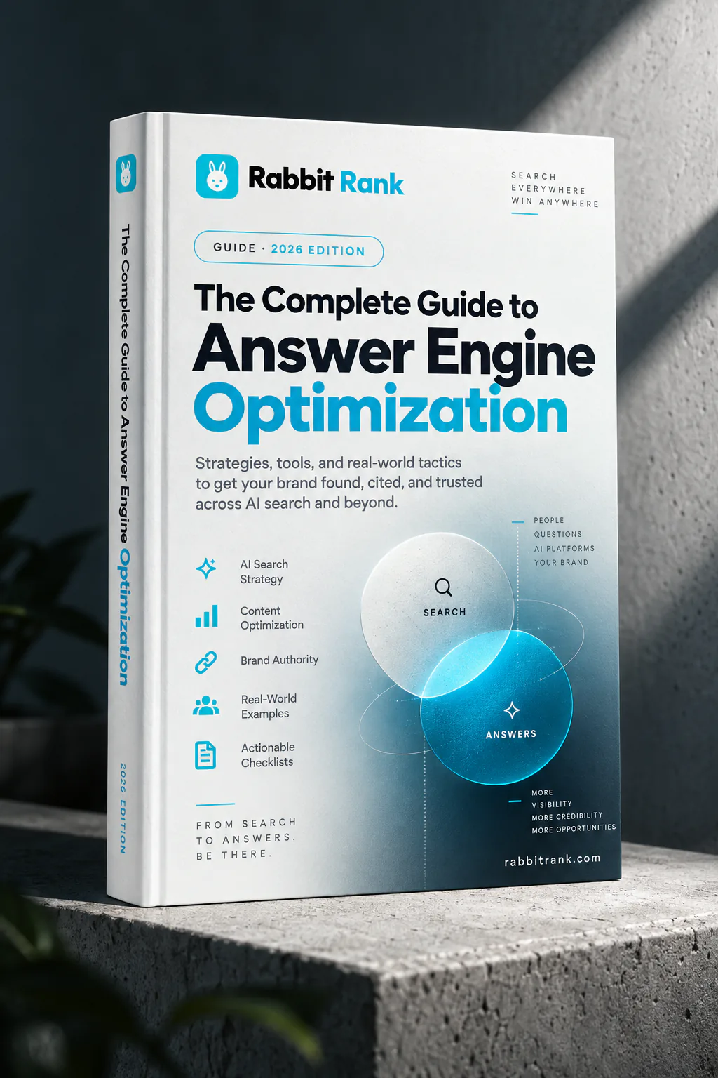 The Complete Guide to Answer Engine Optimization — the Rabbit Rank eBook standing on a concrete plinth